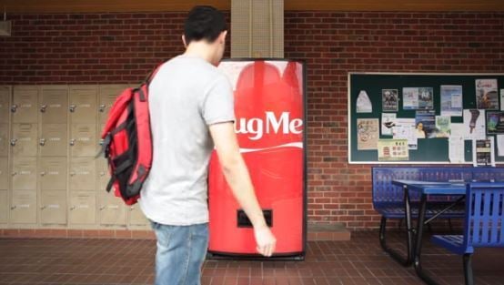 Just hug the machine and you will get a Coca Cola can for free! 