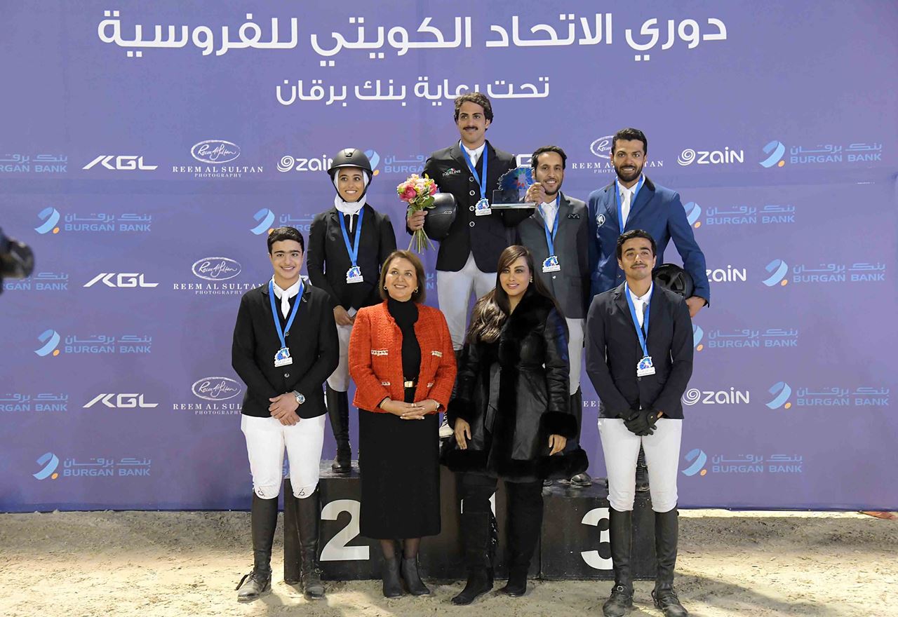 Mr. Talal AlAyar, Public Relations Officer at Burgan Bank, in a group photo with the winning equestrians 